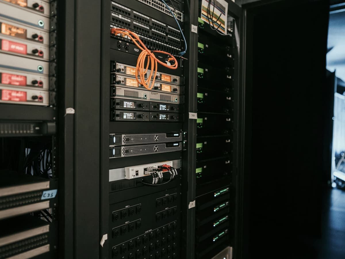 A comms room rack holding network switches, patch panels and rack-mounted equipment.